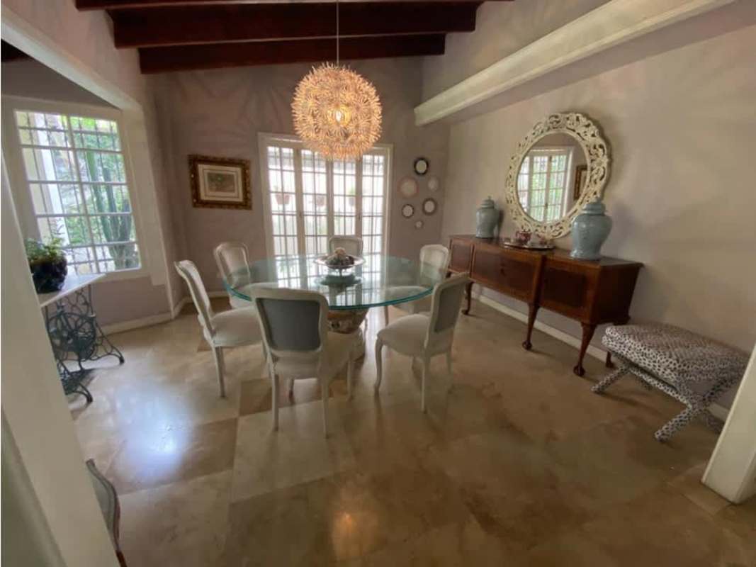 Charming dining area with chandelier, wooden ceiling, marble floor in Altos del Golf Panama