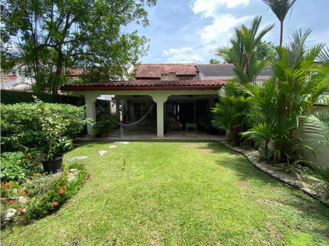 Lush backyard with pool, patio, tropical garden in luxury house San Francisco Panama