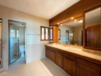 Rustic bedroom with wooden beams, twin beds, tropical style Coronado Panama beach house