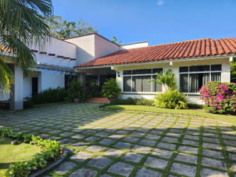 Gourmet kitchen island rustic wood finishes decorative tiles large windows natural light Coronado golf villa Panama
