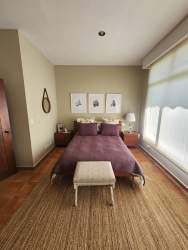 Spacious primary bedroom purple bedding large wardrobe garden views Coronado Golf Resort Panama