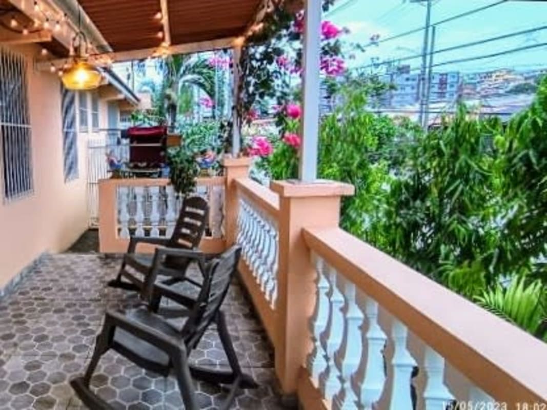 Porch with chairs string lights garden view PH Villa de Vizcaya Condado del Rey
