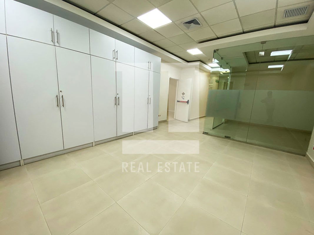 Office interior with built-in cabinets, glass walls, tiled floors at PH Beta 120 Vía España Panama City