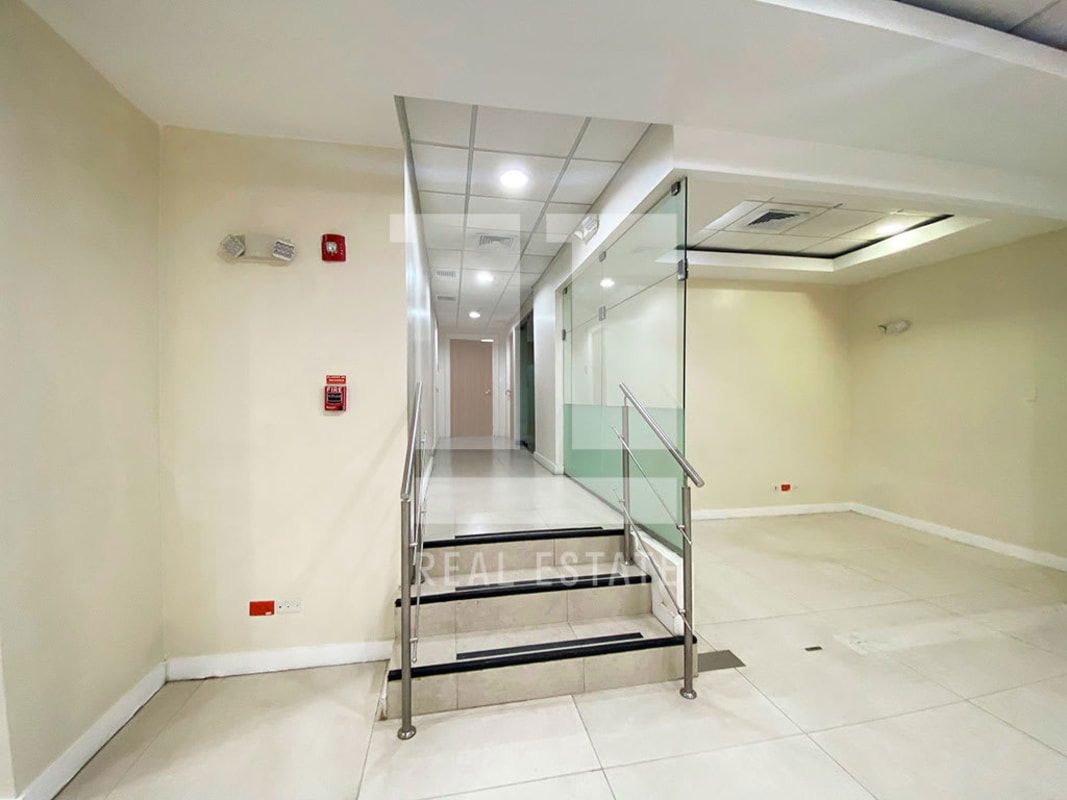 Spacious commercial restroom with granite counters, tile overlays, and privacy stalls at PH Beta 120 Panama