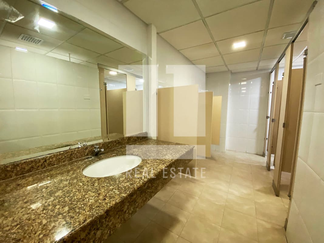 Modern empty office space with tile flooring, drop ceiling, recessed light inside PH Beta 120 Panama