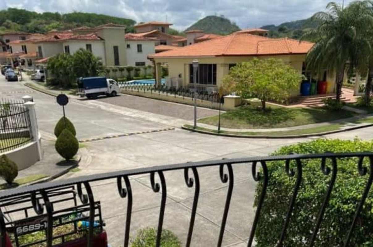 Mediterranean style gated neighborhood with red tile roofs and manicured landscaping