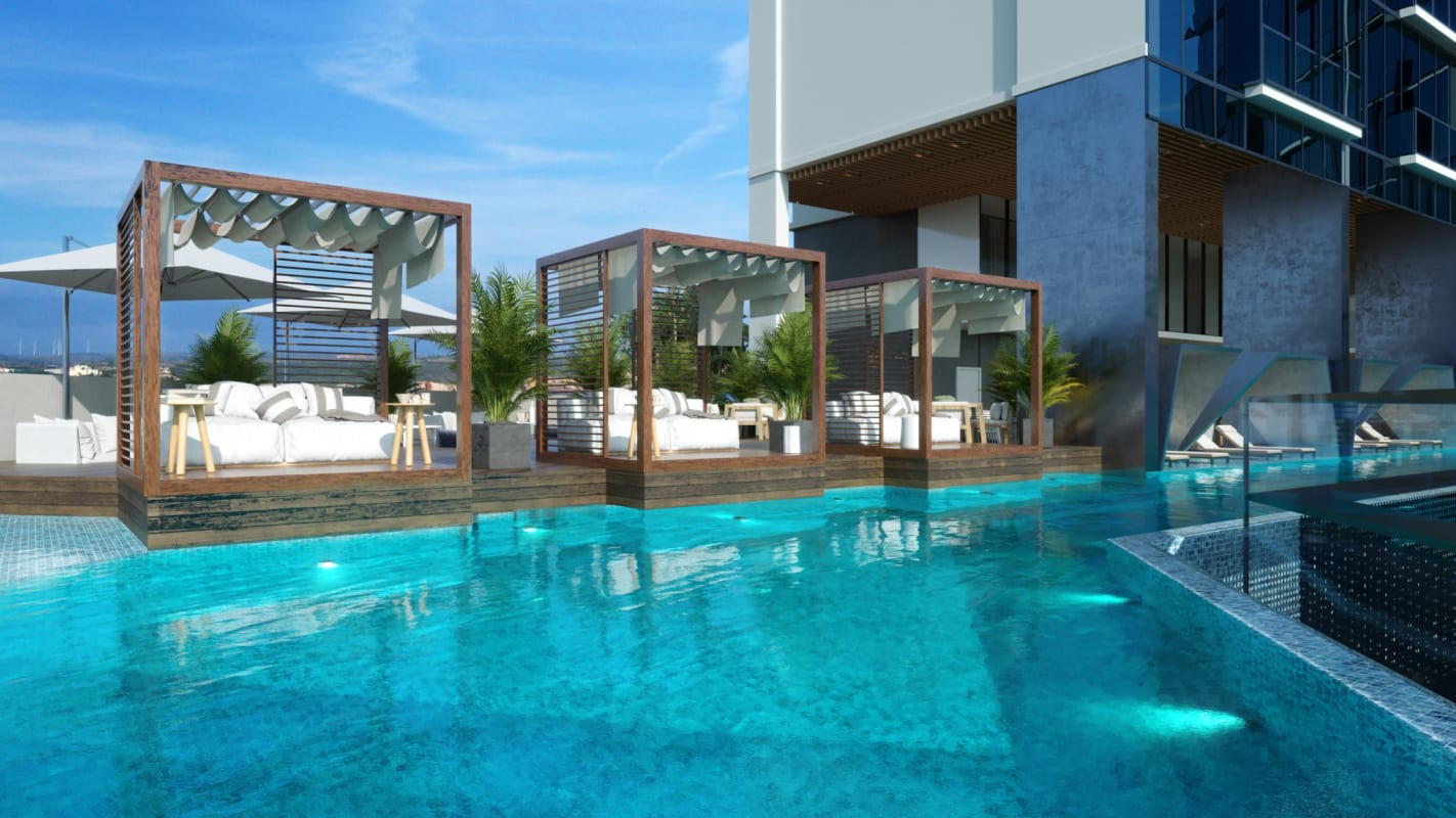 Rooftop pool area with glass facade and sun loungers Costa del Este Panama