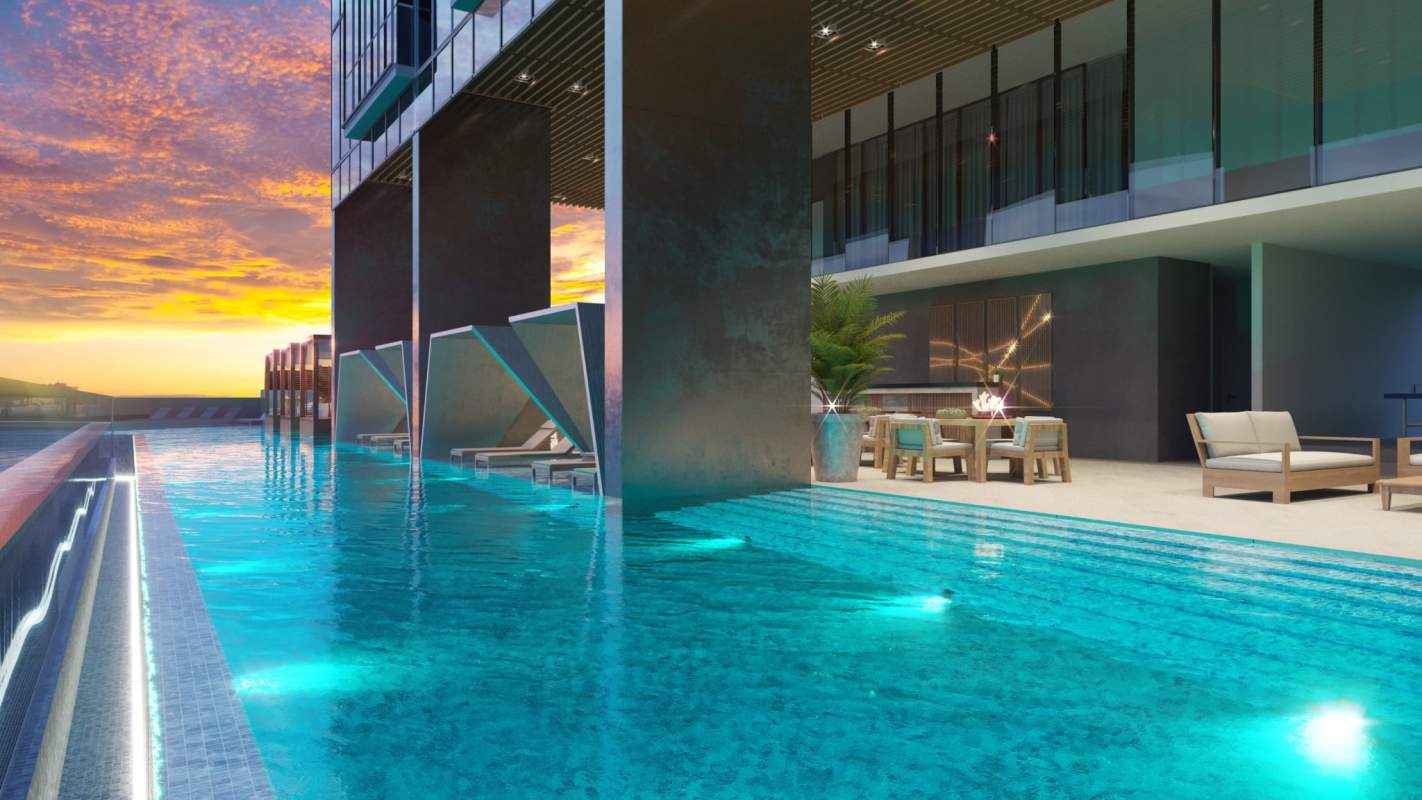 Infinity pool with sunset cityscape and lounge area PH Generation JR Costa del Este