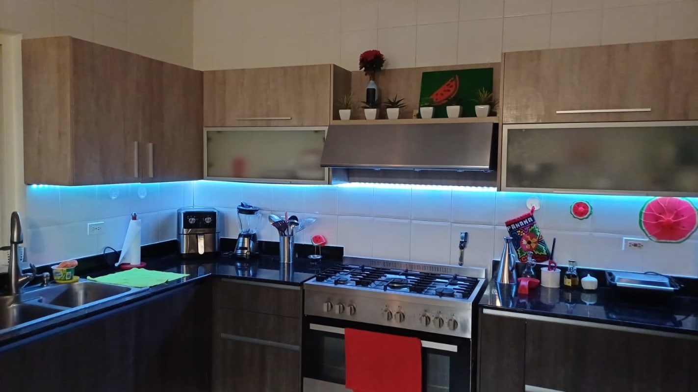 Staircase with artistic railing and chandelier inside PH Villa Valencia Costa Sur home