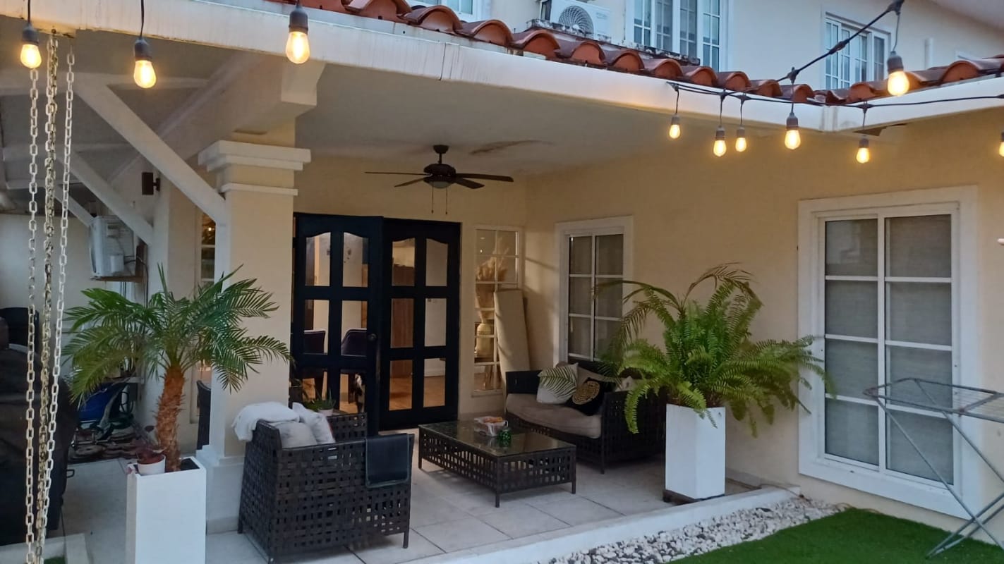 Landscaped backyard with string lights, privacy wall, plants in PH Villa Valencia Costa Sur