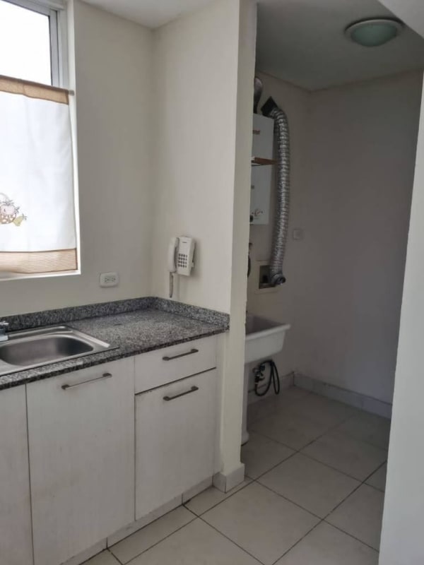 Modern kitchen with granite countertop, stove, oven and hood in apartment Panama City