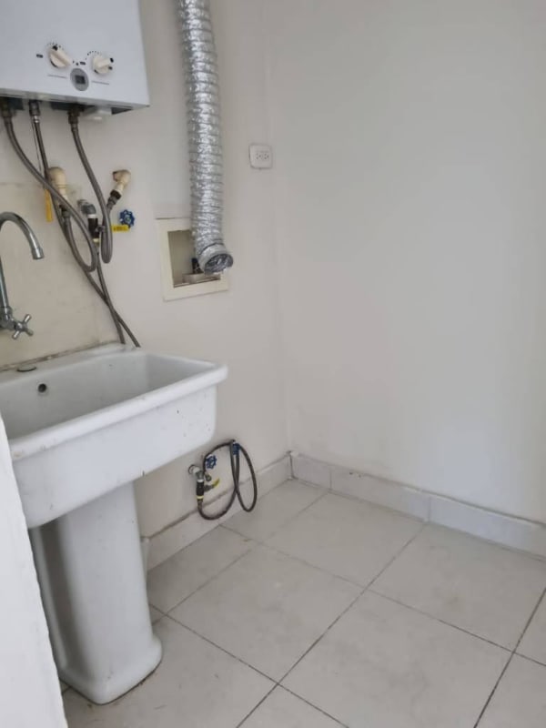Laundry room with sink, water heater and washer connection in Panama apartment at Torres de Cantabria