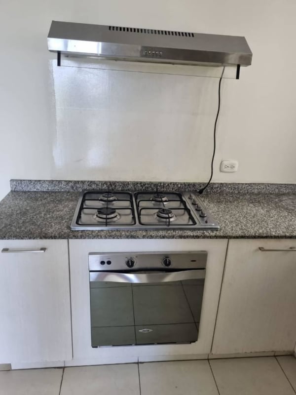 Contemporary kitchen with granite countertops, gas stove and built-in cabinets in Panama apartment for sale