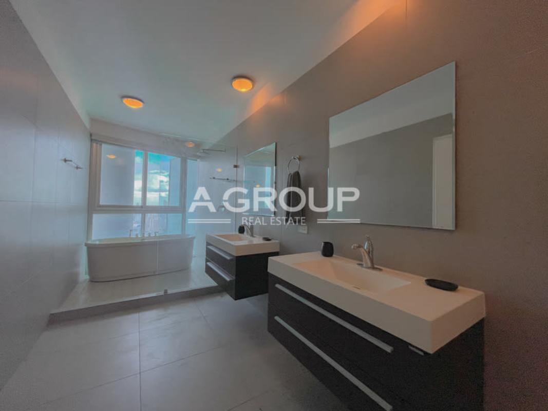 Luxurious bathroom with double vanity sinks, freestanding tub and large windows PH Yacht Club Panama