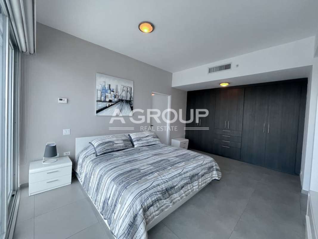 Furnished bedroom featuring floor to ceiling windows city skyline view in Yacht Club Ave Balboa Panama