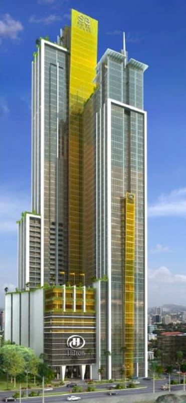Exterior view tall glass facade of PH BICSA Tower Hilton Panama on Avenida Balboa