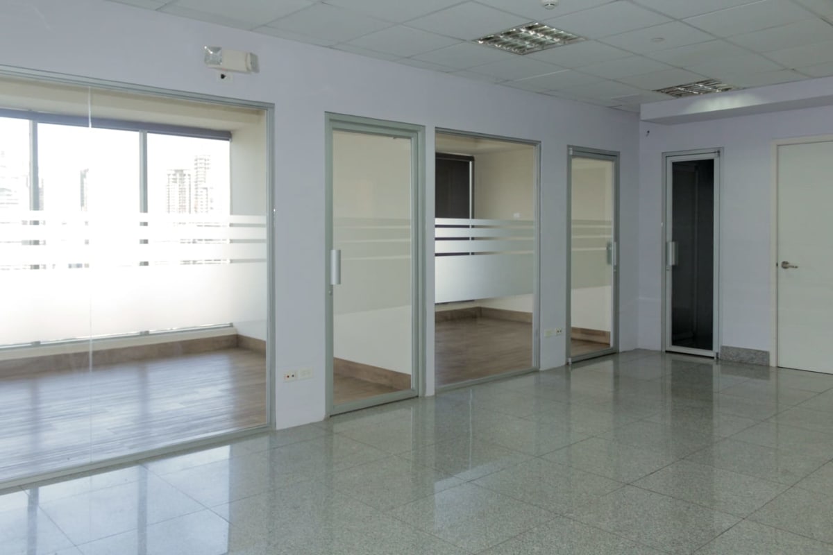 Modern office interior with glass walls and panoramic window views at PH BICSA Panama
