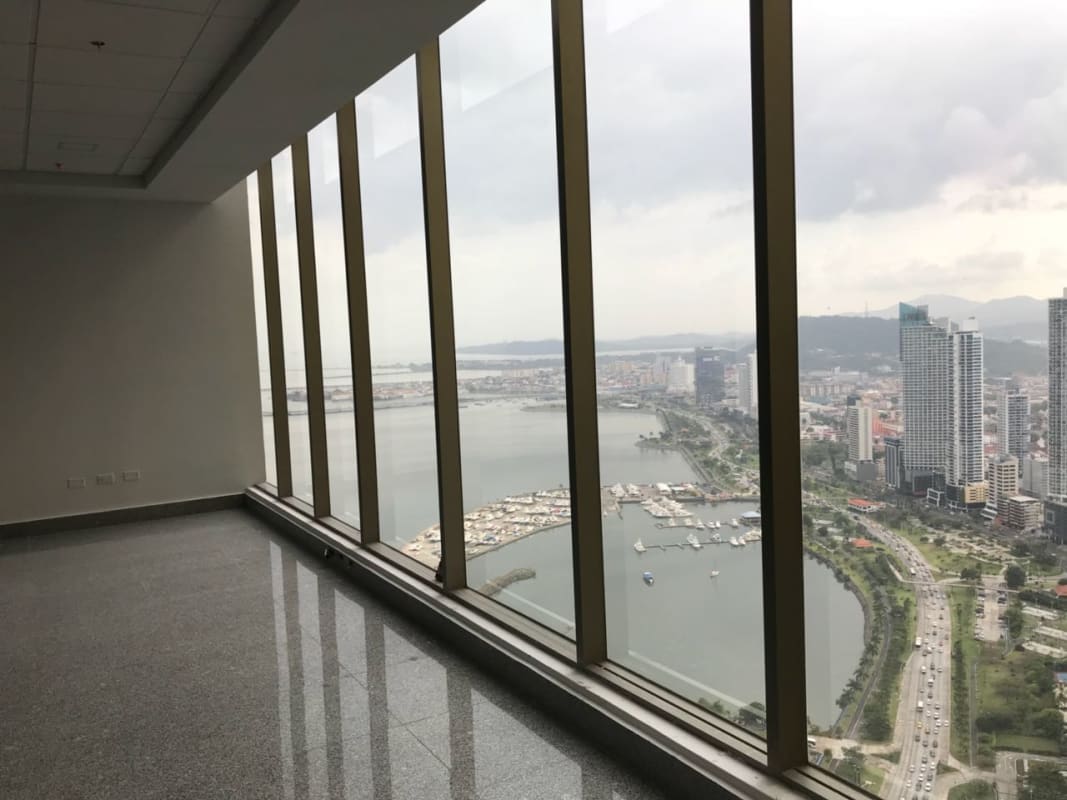 Open office with floor-to-ceiling windows cityscape and waterfront PH BICSA Panama