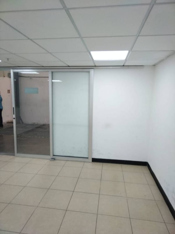 Vacant commercial lobby area with glass sliding door tiled floor in Panama