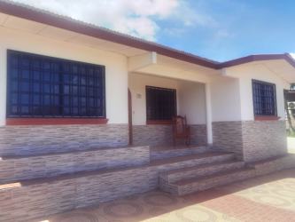 Front porch entrance of house with iron bars, tile details in Urbanizacion Rio Escondido for sale