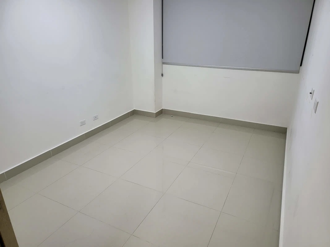 Bedroom with large windows offering ocean views, built-in closet, and tile flooring in PH Balboa Bay Panama