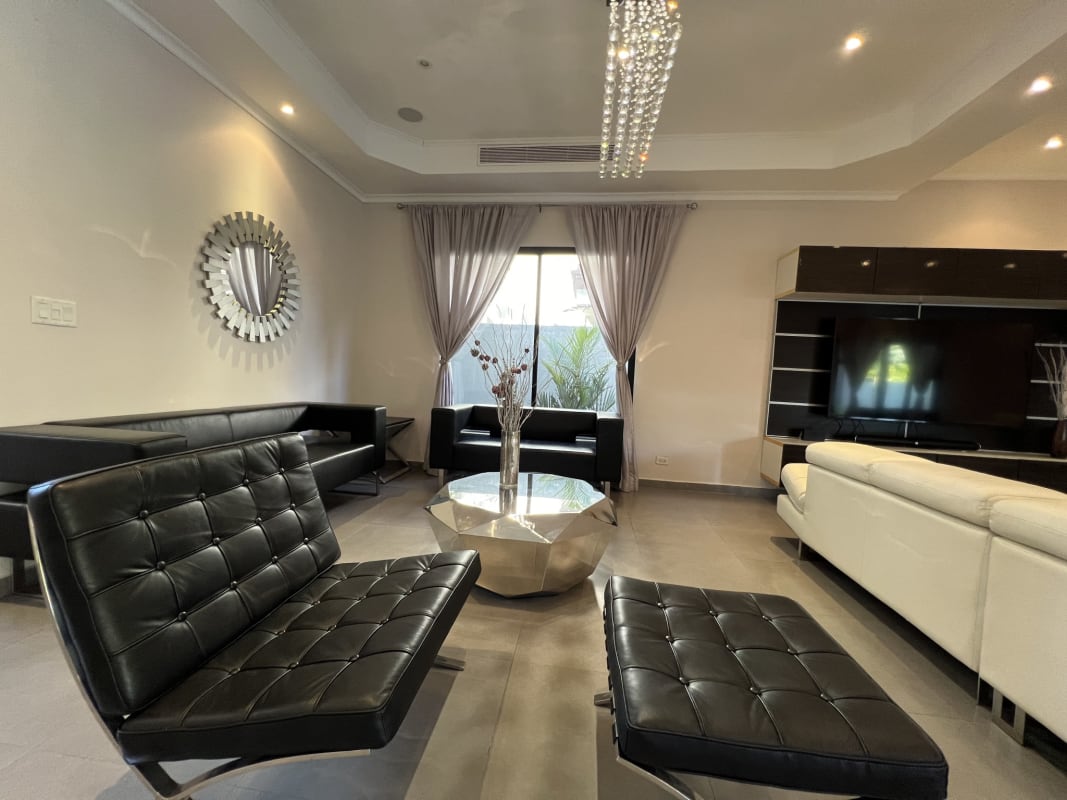 Elegant living room with marble floors, large windows, modern decor in Magnolias Costa del Este