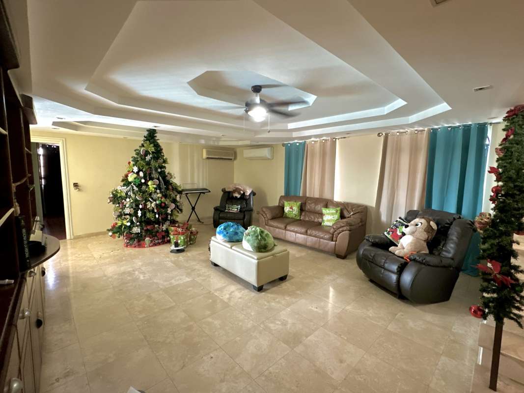 Living room marble floors, beige sofas, chandelier holiday decorated villa Las Cumbres Panama