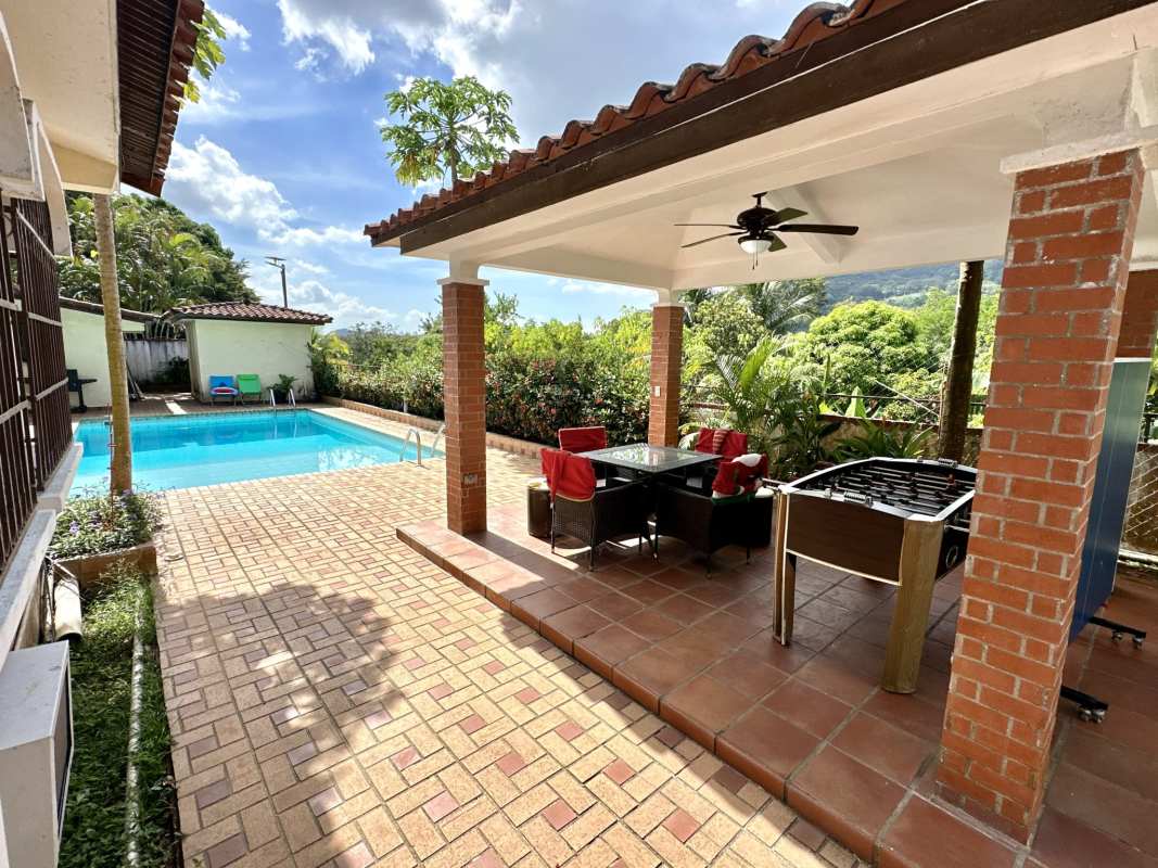 Covered patio with pool, brick columns, mountain views Las Cumbres Panama