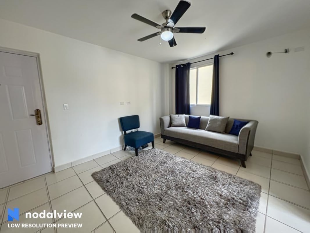 Minimalist living and dining room with natural light and ceiling fan in PH Villa Lucre Panama