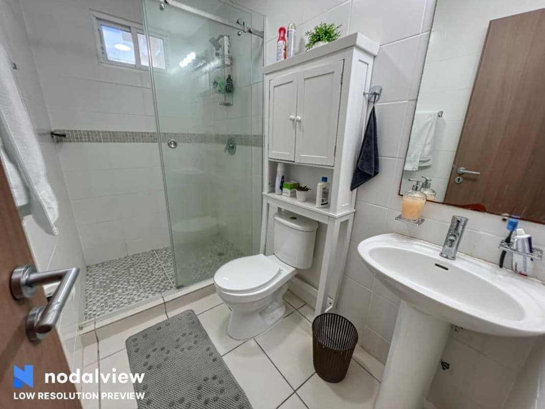 Modern bathroom with glass shower and pedestal sink in PH Villa Lucre Panama City