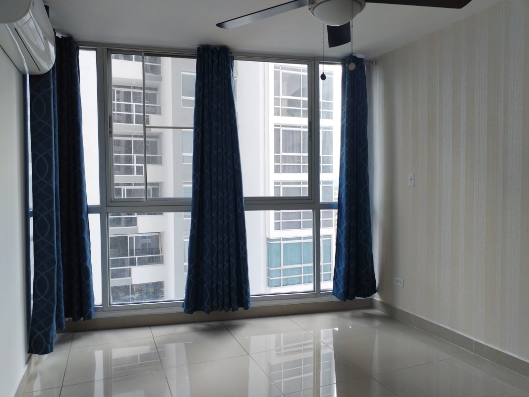 Bedroom with large windows, tile floors, curtains, ceiling fan in PH Coral Towers Panama City