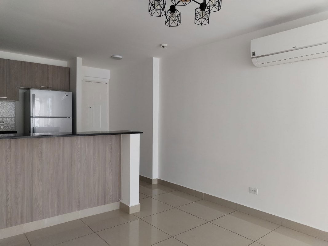 Open kitchen with mosaic backsplash, refrigerator, and stove in apartment for sale Panama City