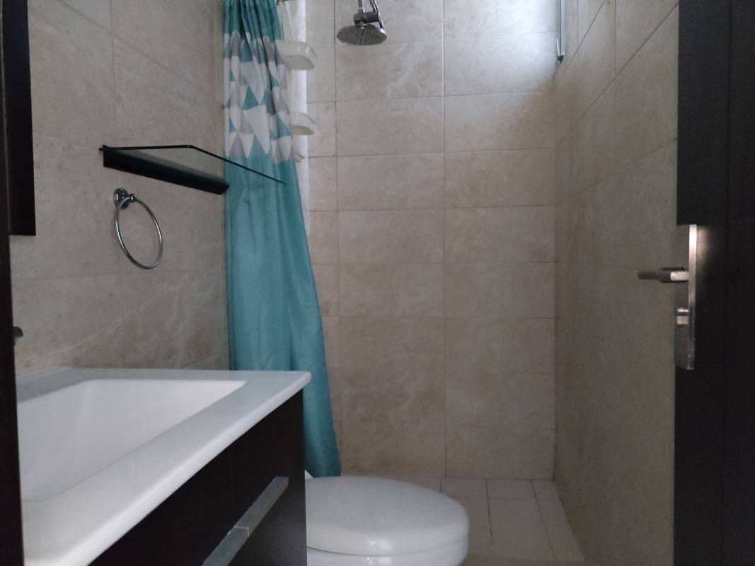 Modern bathroom with shower, tiled walls and fixtures in PH Coral Towers Panama City