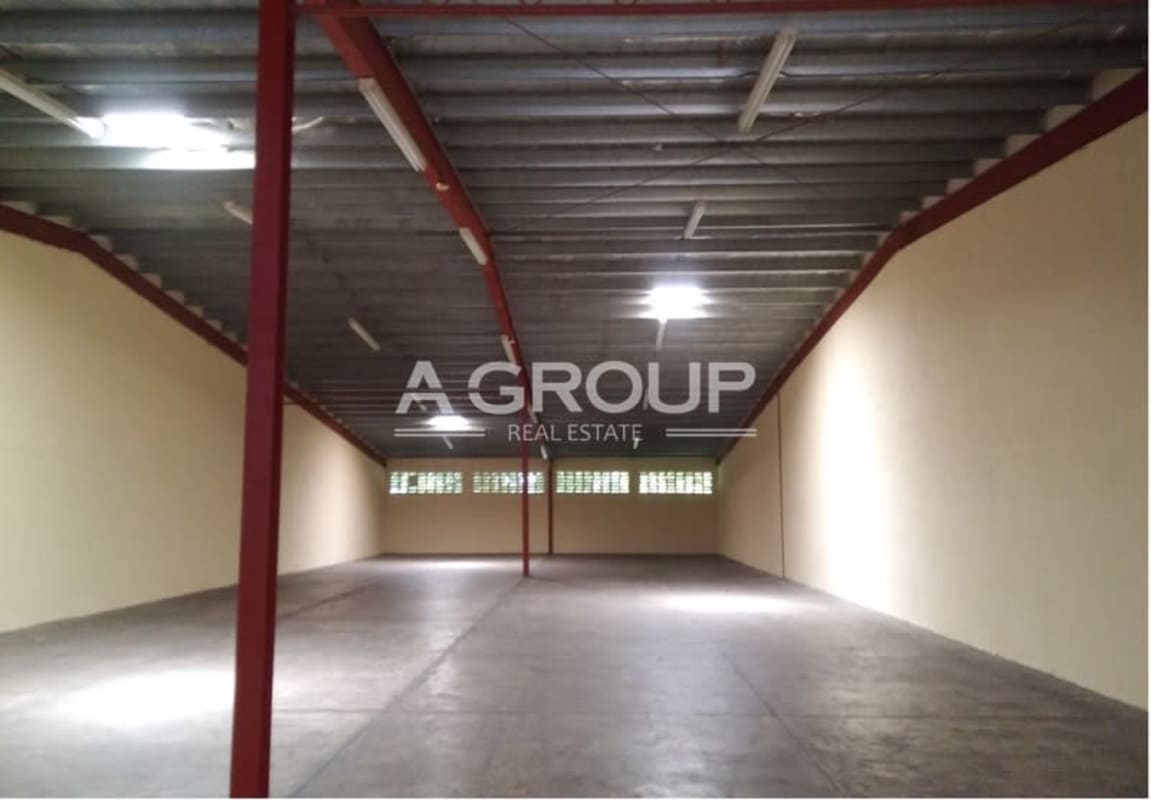 Exterior with wide rolling metal doors and truck access unloading bay El Crisol Panama