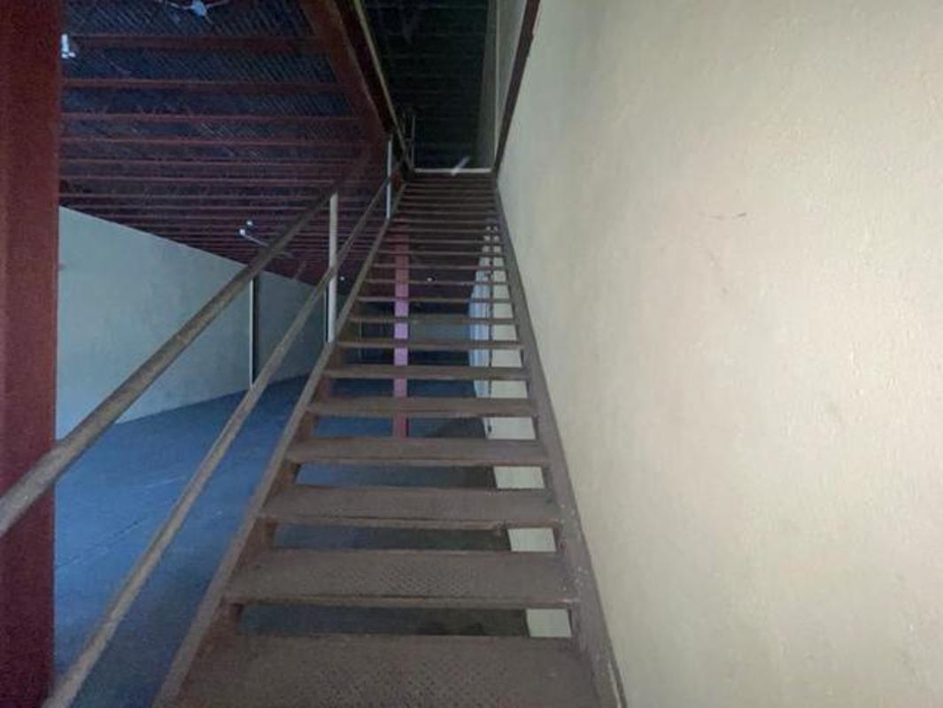 Warehouse mezzanine level with steel staircase and railing El Crisol Panama