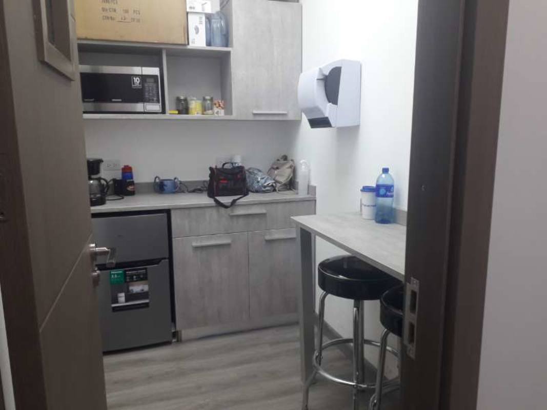 Small kitchenette with appliances and bar counter in commercial building Albrook Panama