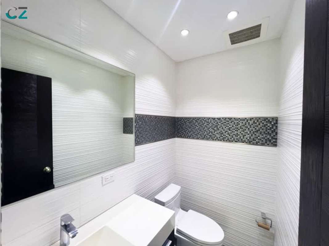 Sleek bathroom with mosaic accent tiles in Oceania Business Plaza Panama commercial office