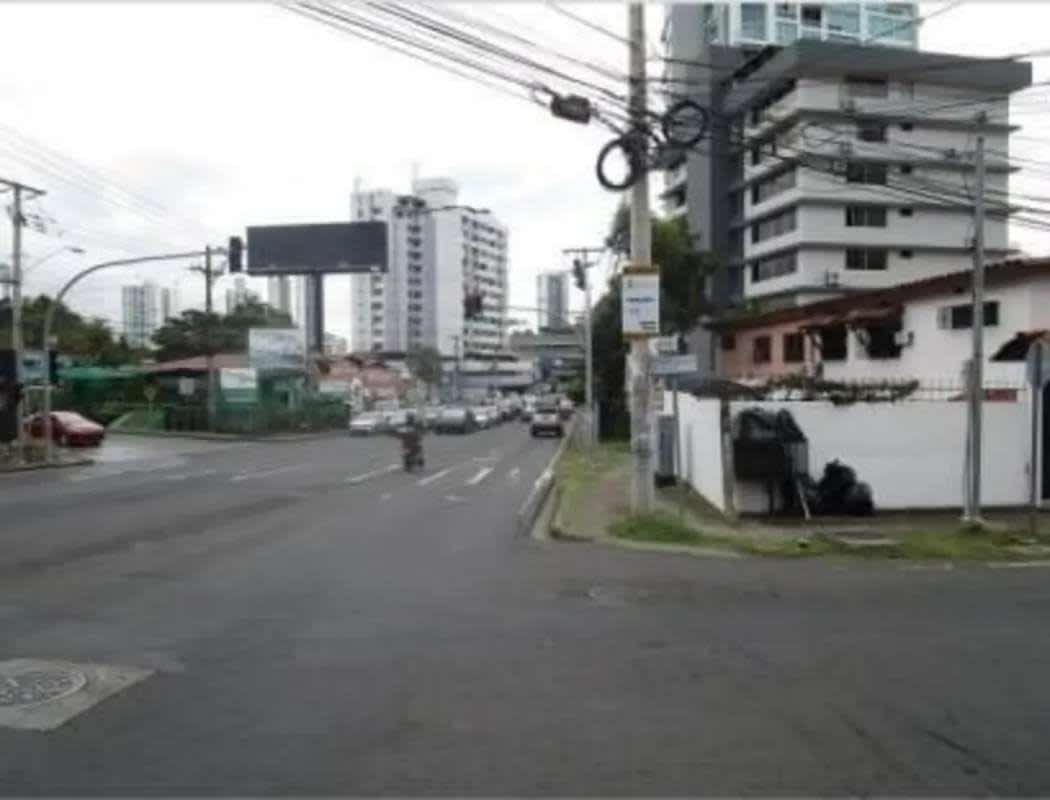 City intersection view with residential houses, traffic, power lines at Via Porras San Francisco Panama