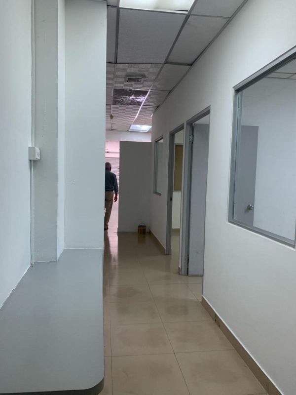 Commercial hallway with glass partitions, tiled flooring and drop ceiling in Plaza Via España Panama City