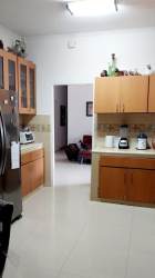 Bedroom with large window, blue walls, AC, and garden views in house for sale Howard Panama Pacifico