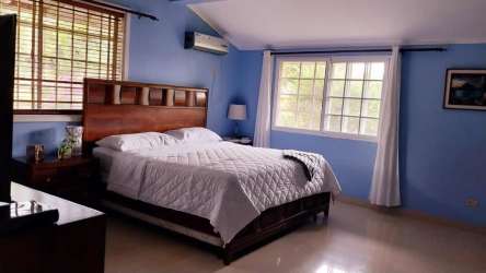 Living room with large window, ceiling fan, sofa set in Panama Pacifico house for sale