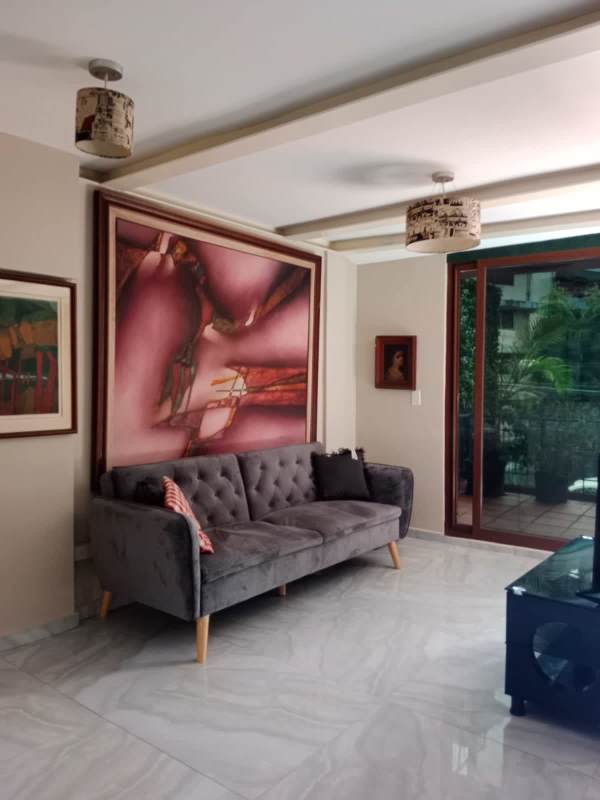 Spacious living area in apartment with seating and decor La Cresta Panama