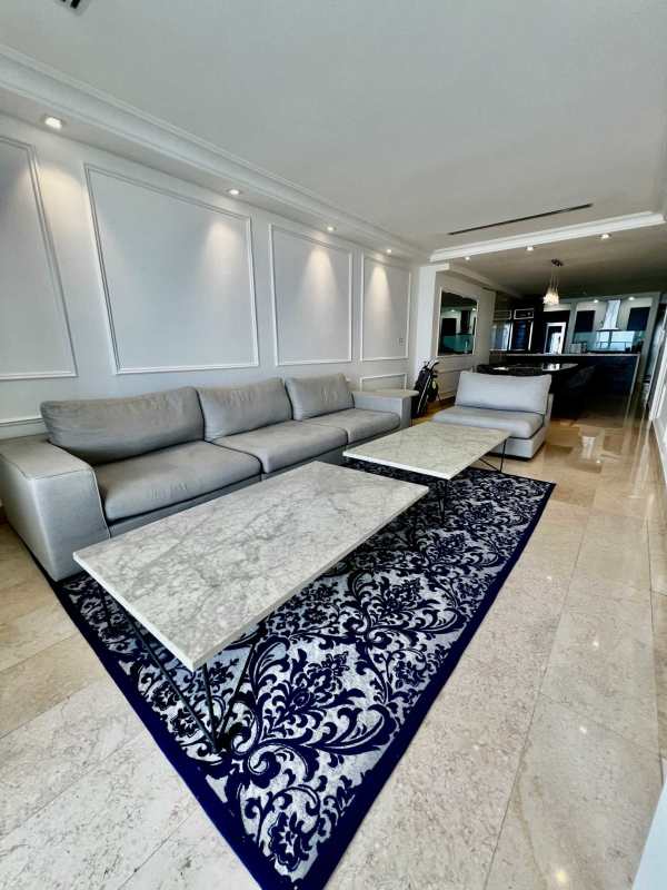 Modern living room with gray sectional sofa, marble tables, elegant decoration in Yoo Panama