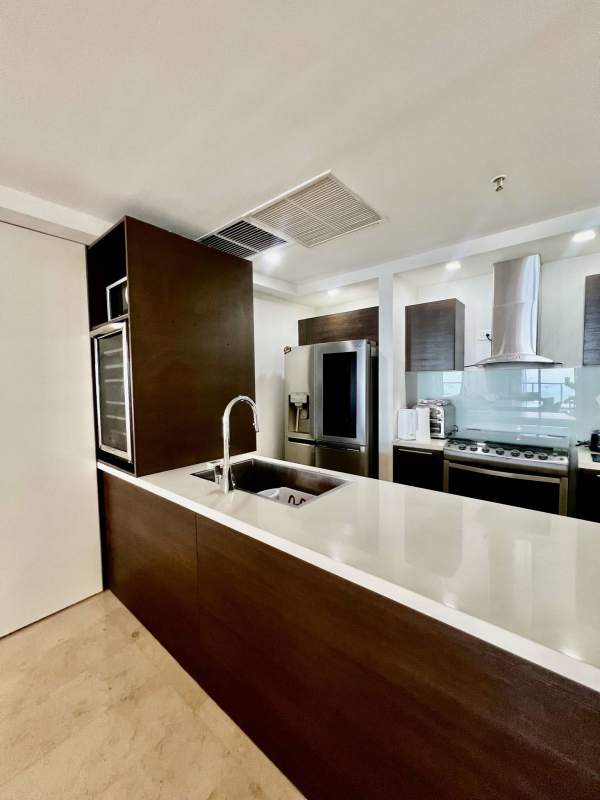 Spacious bedroom with floor-to-ceiling windows, panoramic city view in Yoo Panama condo