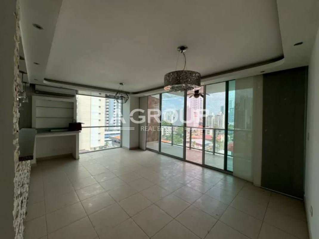 Spacious living room with porcelain tile floors, balcony, large windows and AC at PH Tao Tower