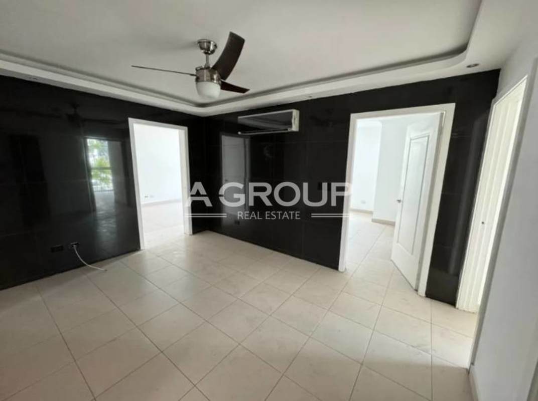 Bedroom with panoramic window, white walls, porcelain tiles in PH Tao Tower apartment San Francisco Panama