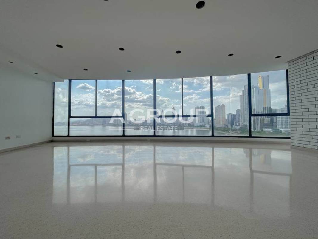 Modern living room with curved floor-to-ceiling oceanview windows Punta Paitilla
