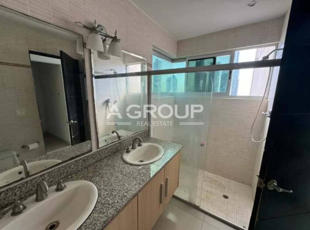 Modern bathroom with double granite-counter sink and walk-in glass shower PH Sevilla Costa del Este