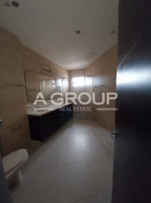 Modern bathroom with double sink vanity, glass shower, beige tiles in Embassy Village Clayton Panama