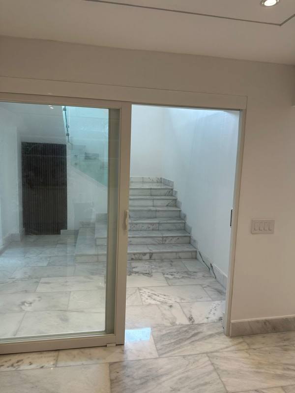 Private luxury house exterior view with swimming pool, gardens, balcony and palm trees in Altos del Golf Panama City